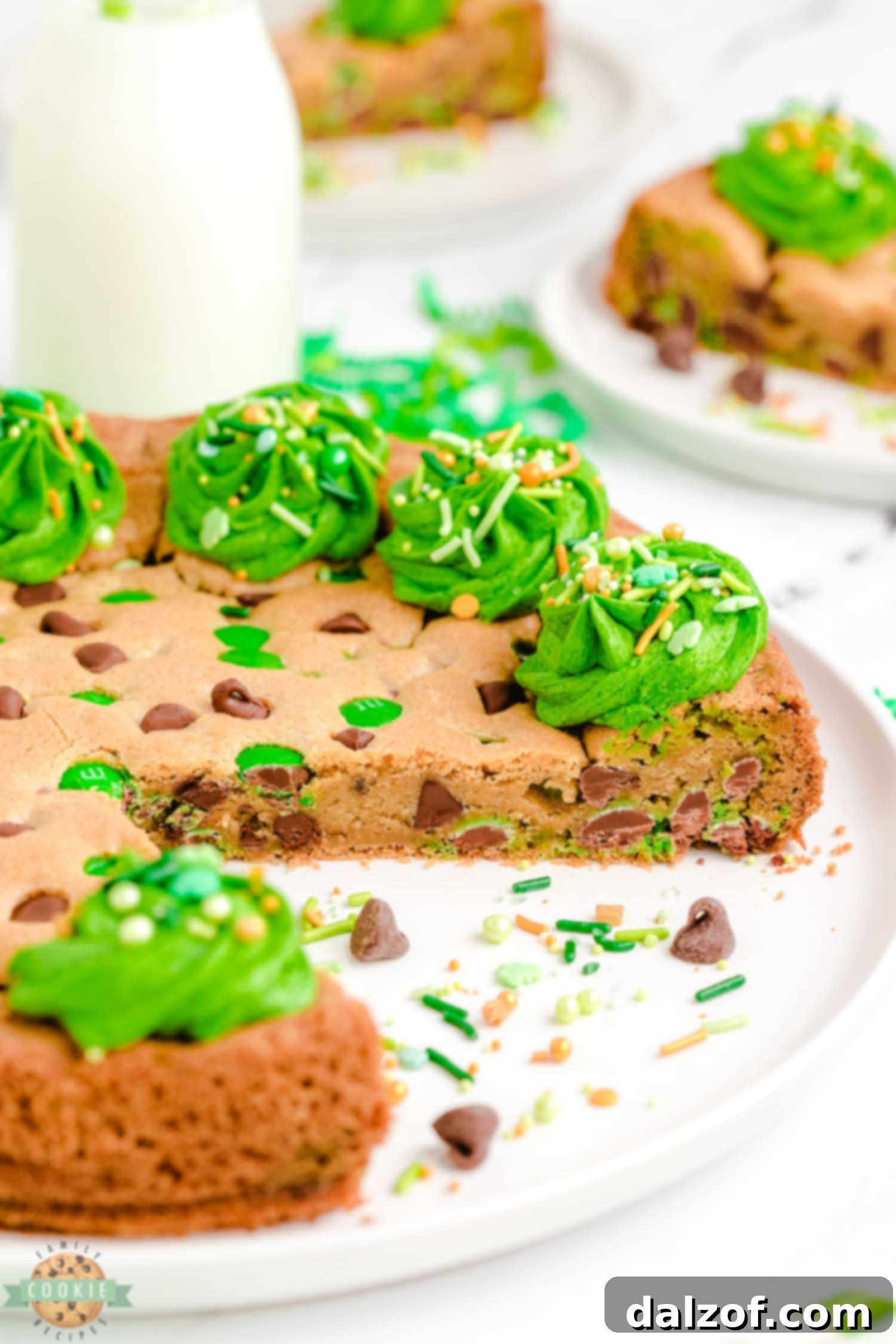 A slice taken out of a St. Patrick's Day cookie cake with green frosting