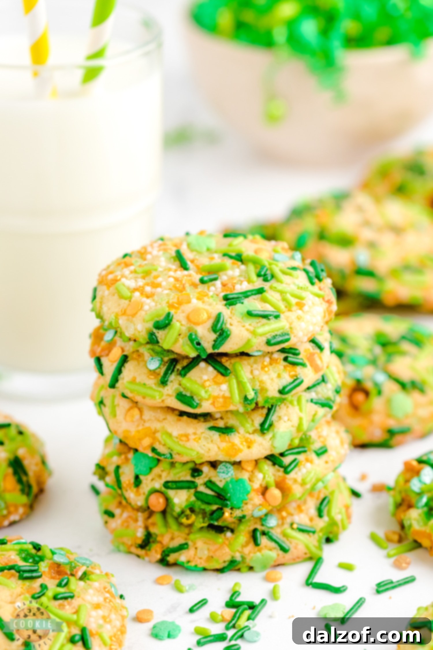 Stack of soft and chewy pudding cookies rolled in green and gold sprinkles, a perfect St. Patrick's Day treat.
