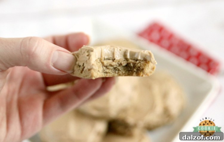 Close-up of a stack of Root Beer Cookies, highlighting their soft texture and generous buttercream frosting, all infused with root beer extract.