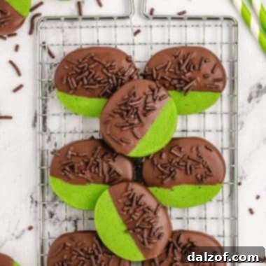 Mint Cookies made from a buttery shortbread cookie dipped in chocolate & topped with chocolate sprinkles. Green Mint Cookies perfect for St. Patrick’s Day!