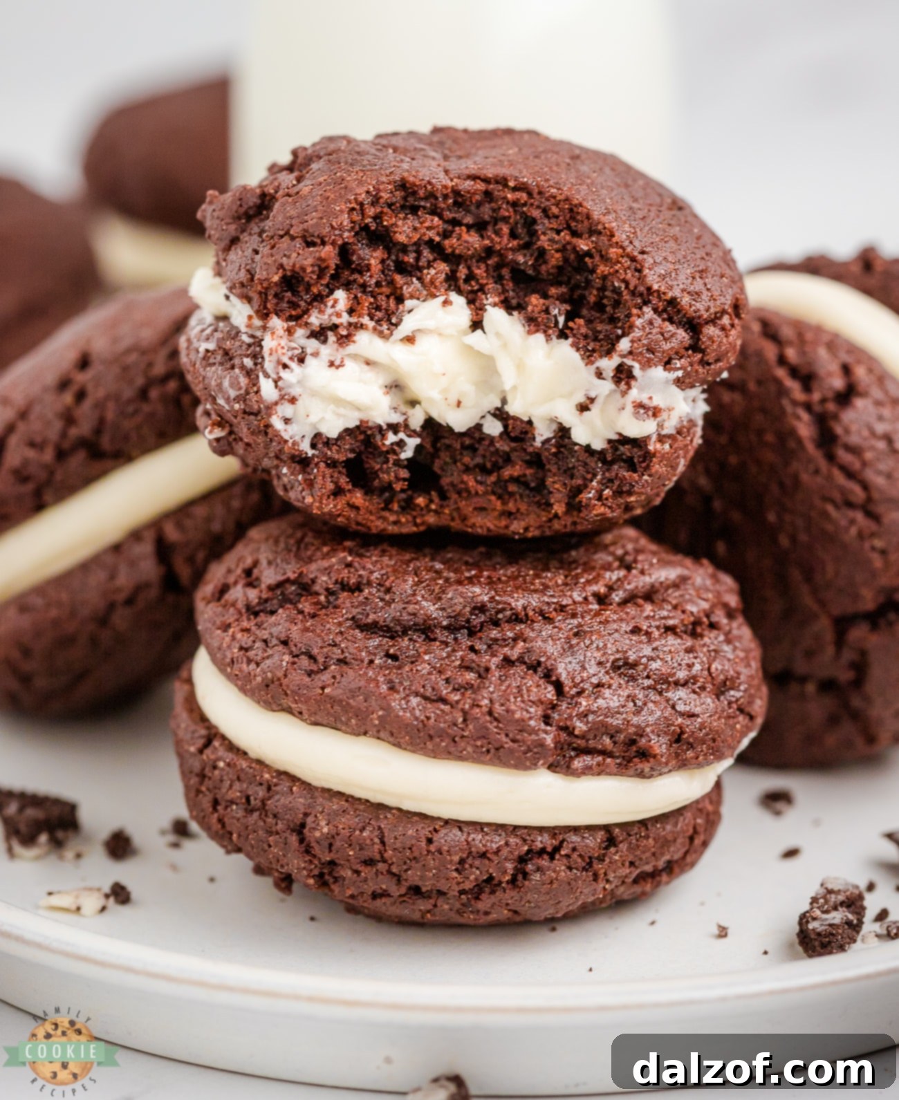 A delicious homemade Oreo cookie with a bite taken out, revealing the creamy white filling
