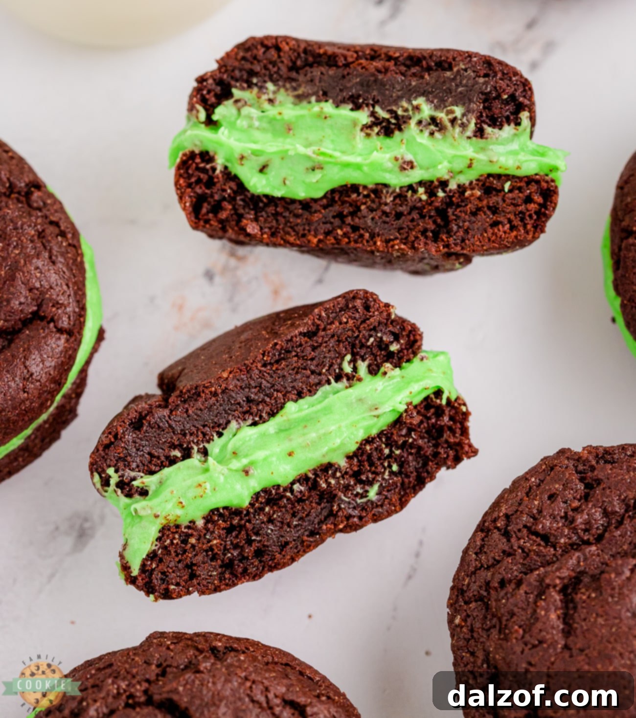 Mint Oreos cut in half to show the green cream cheese filling