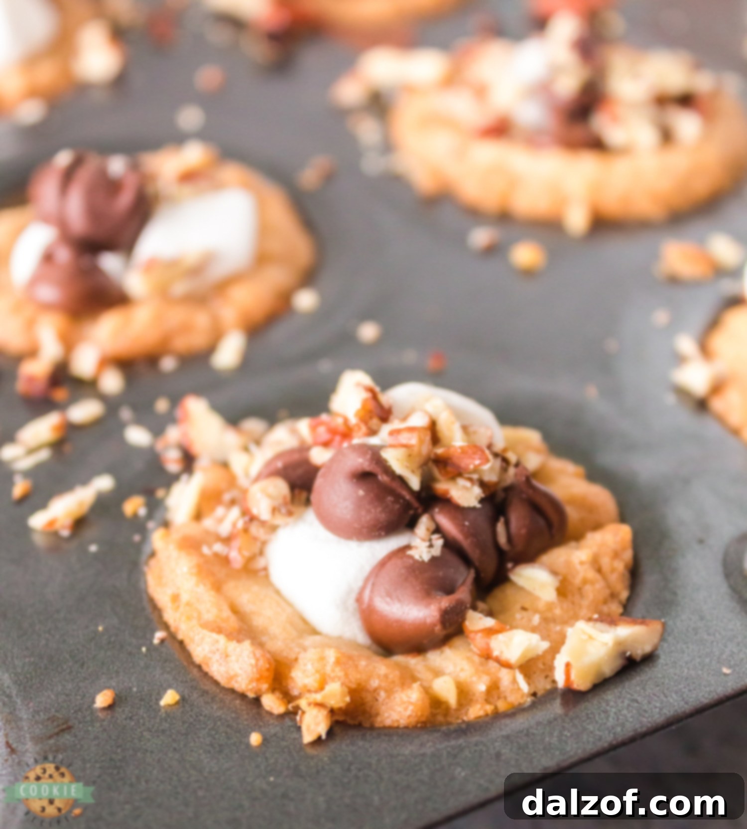 Mini Rocky Road Cookies baking in a non-stick mini muffin tin, showcasing the cup shape.
