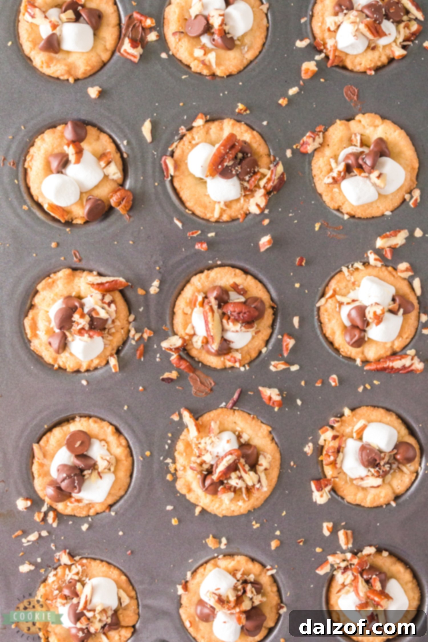 Rocky Road Cookies dough pressed into a mini muffin pan, forming cup shapes before baking.