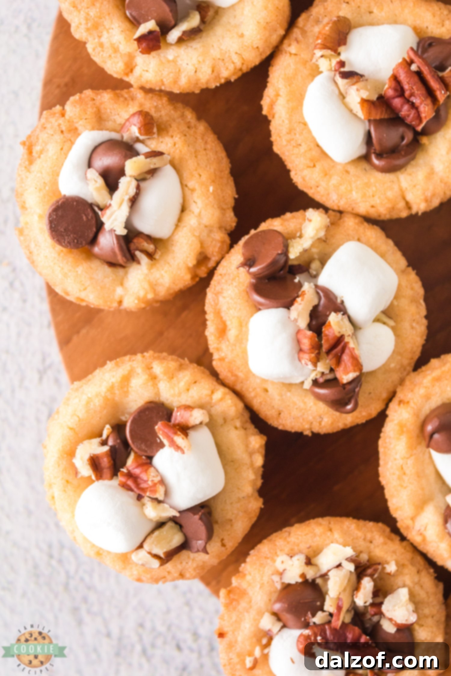 Close-up of Rocky Road Cookie Cups, showing the melted chocolate, soft marshmallows, and crunchy pecans.