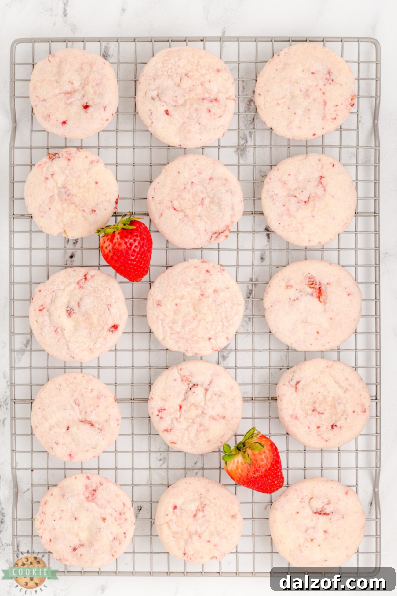 sugar cookies made with strawberry cream cheese on a cooling rack
