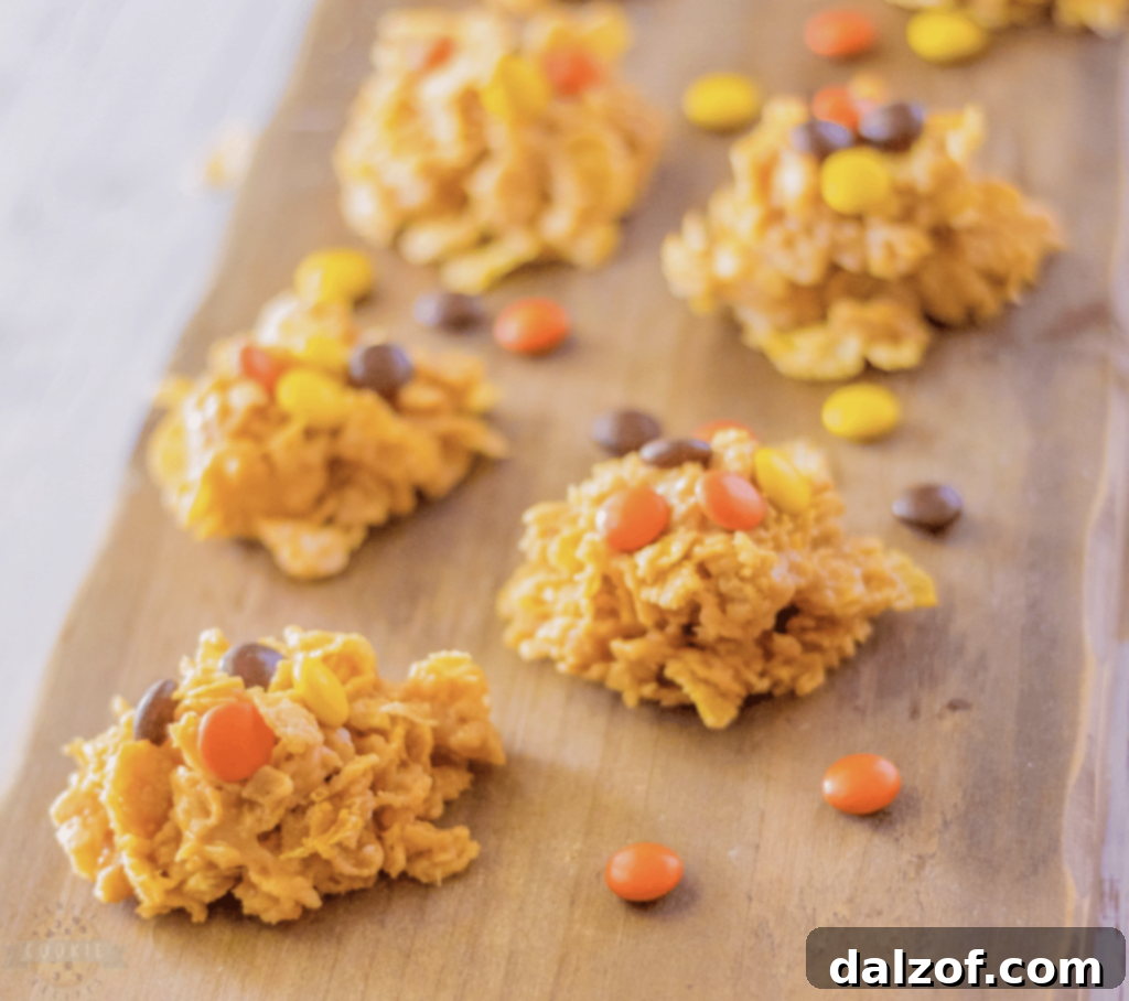 Irresistible Peanut Butter Cookies 16 No-bake Peanut Butter Cornflake Cookies made with 5 ingredients, featuring peanut butter, cornflake cereal, sugar, and Reese's Pieces for a fun and tasty treat.