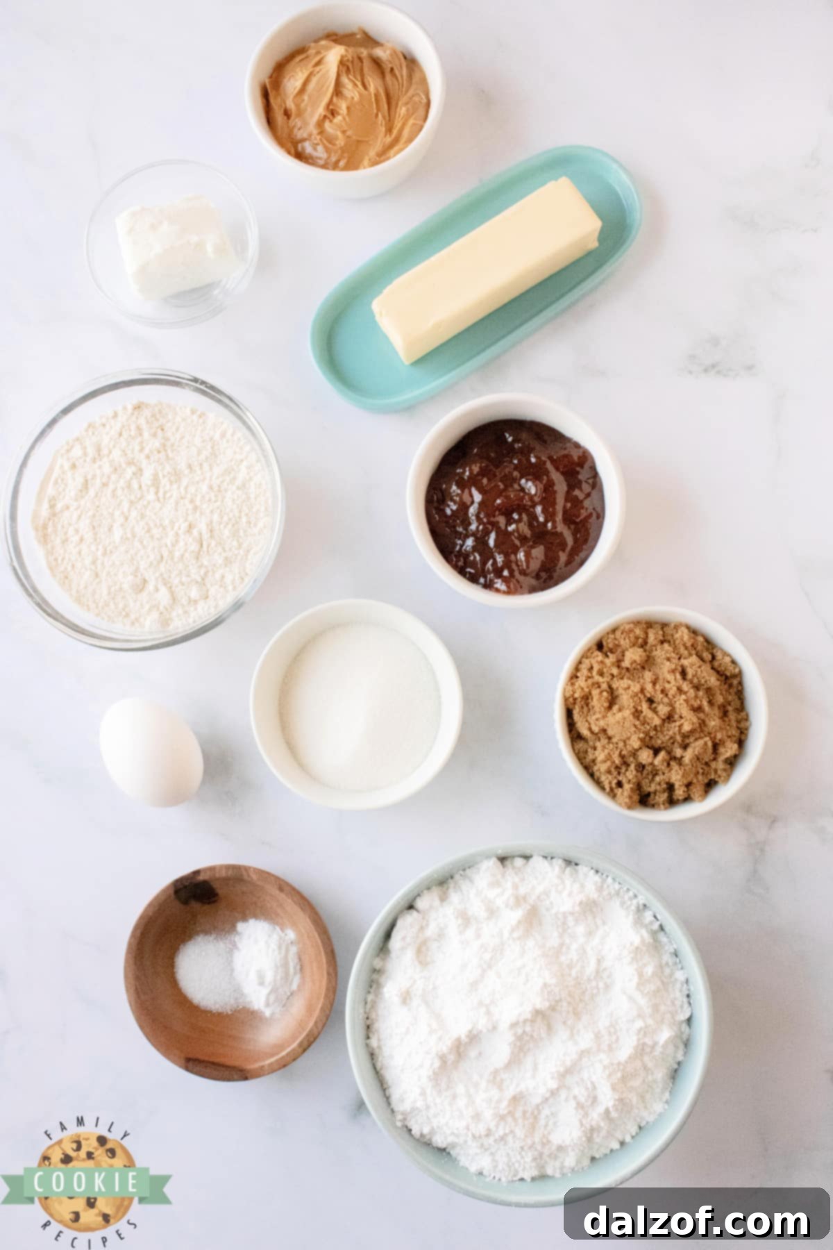 A collection of fresh ingredients laid out, ready for making delicious Peanut Butter and Jelly Sandwich Cookies.