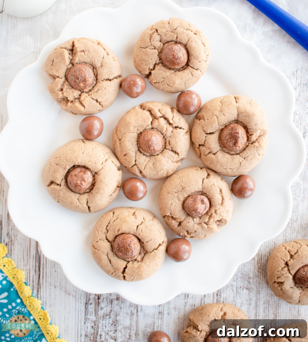 Close-up of chocolate malt Whopper cookies on a white plate, showcasing their inviting texture