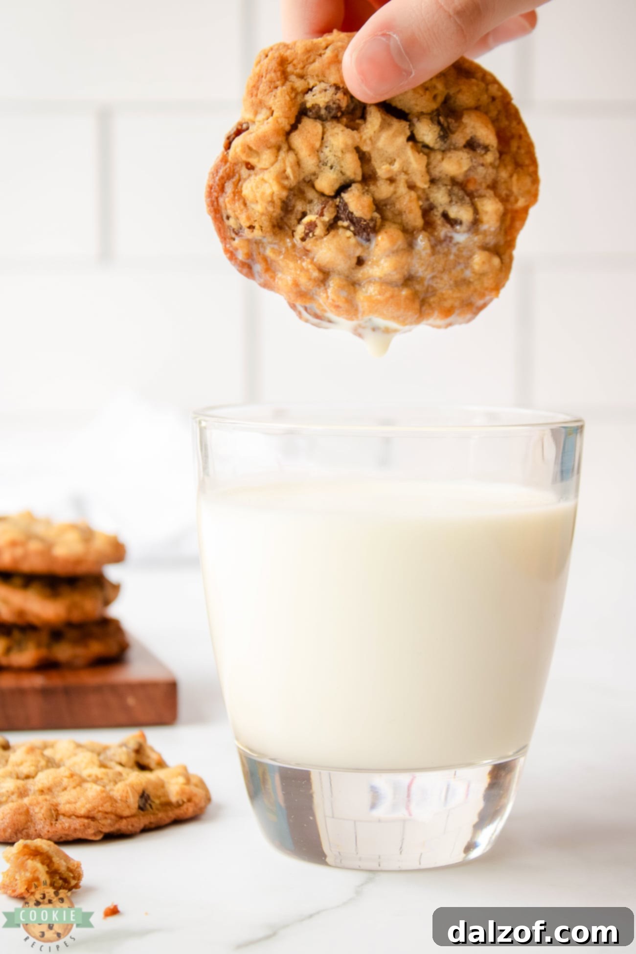 dunking oatmeal raisin cookie in milk