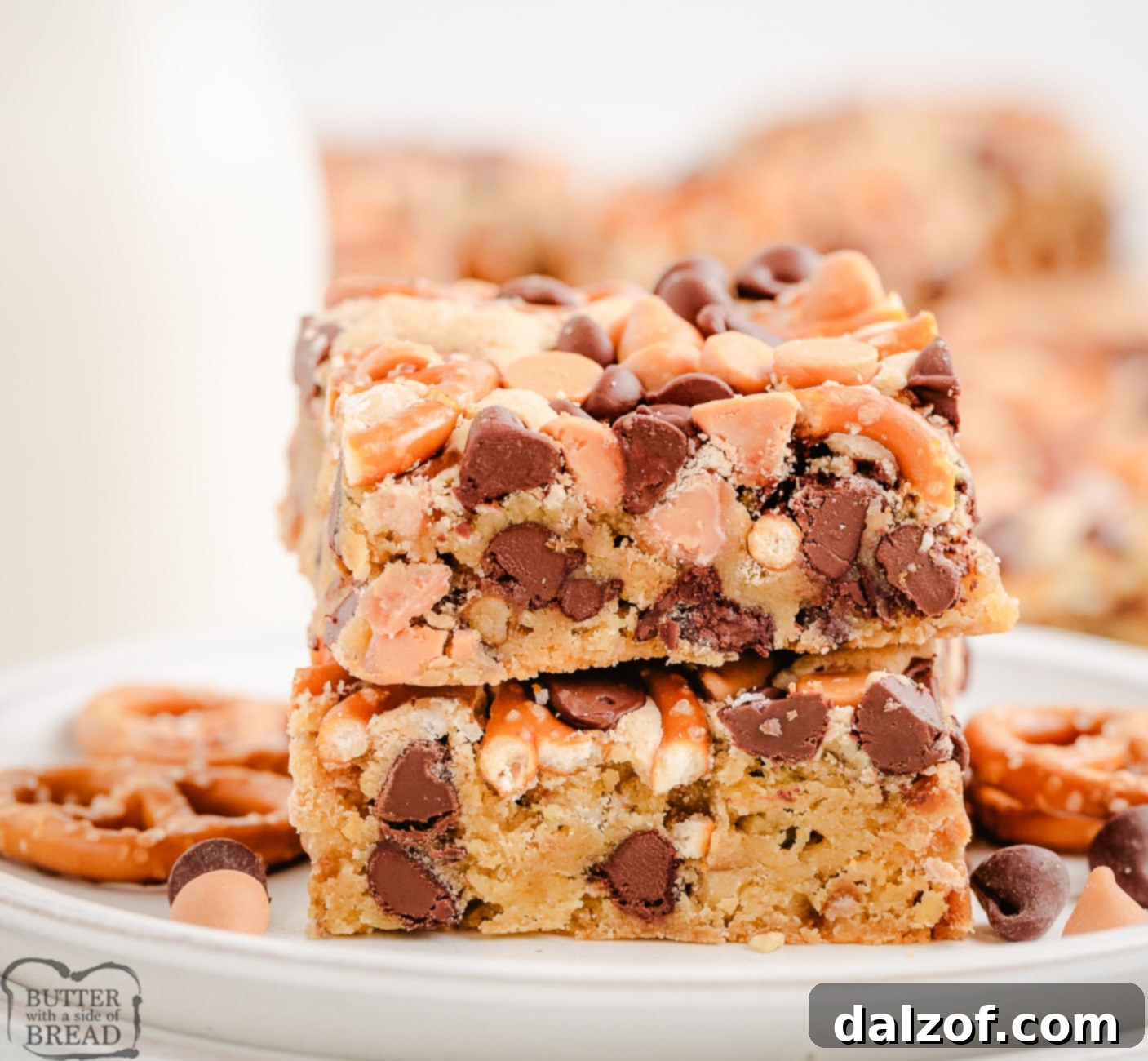 A stack of butterscotch pretzel cookie bars on a cooling rack, showcasing their thickness and delicious layers.