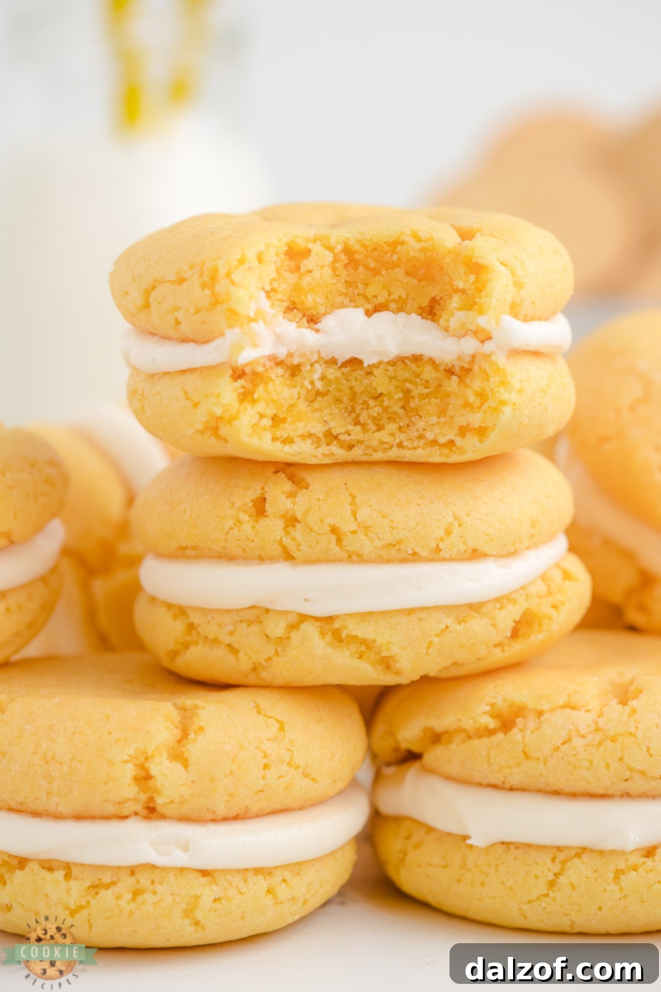 A homemade Golden Oreo cookie with a bite taken out, showing the creamy filling