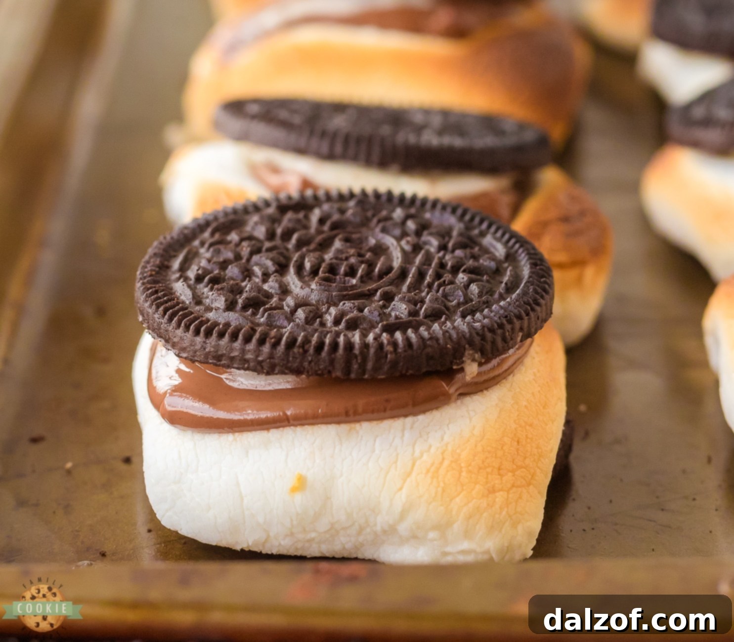 Close-up of Oreo S'mores with melted marshmallow and chocolate between cookies.