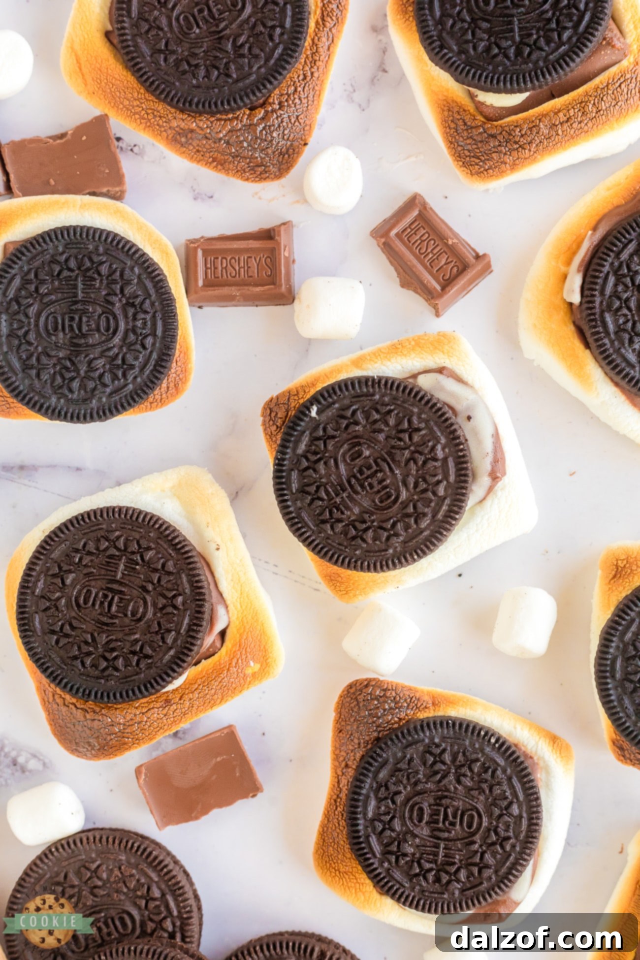 Oreo cookies with toasted marshmallows and melted chocolate inside, ready to eat.