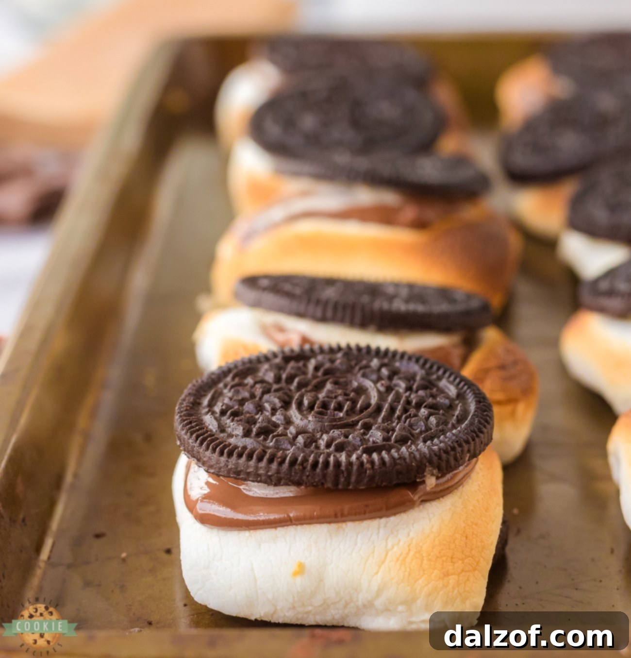 Hot Oreo S'mores on a baking sheet, fresh out of the oven, with melted chocolate and toasted marshmallow.