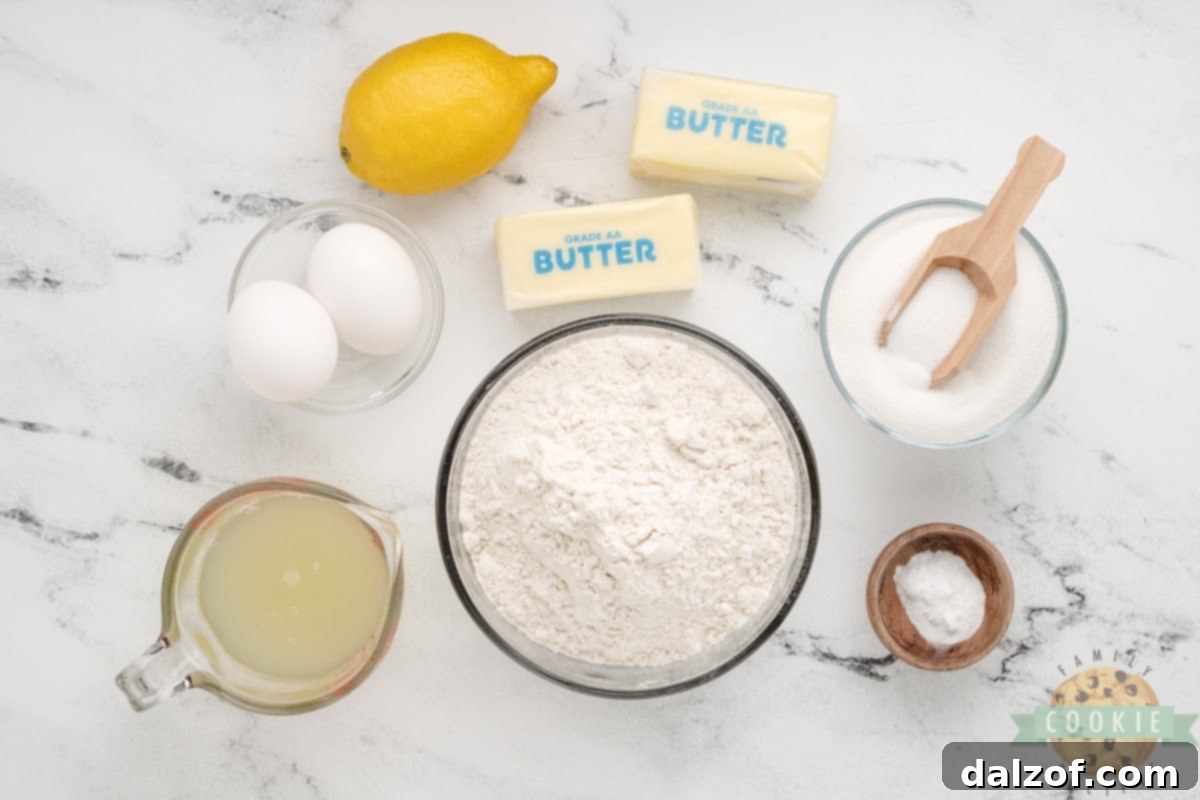 A flat lay of the six essential ingredients for Easy Lemonade Cookies: butter, sugar, baking soda, eggs, frozen lemonade concentrate, and all-purpose flour.