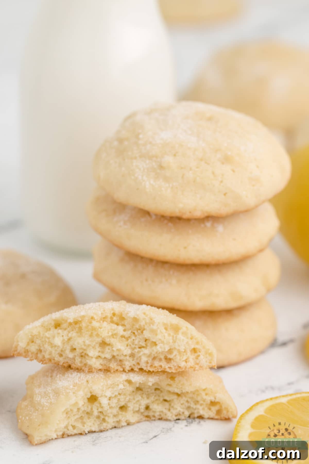 Hand holding a freshly baked lemonade cookie with a light sugar topping, emphasizing the simple and delicious nature of cookies made with lemonade concentrate.