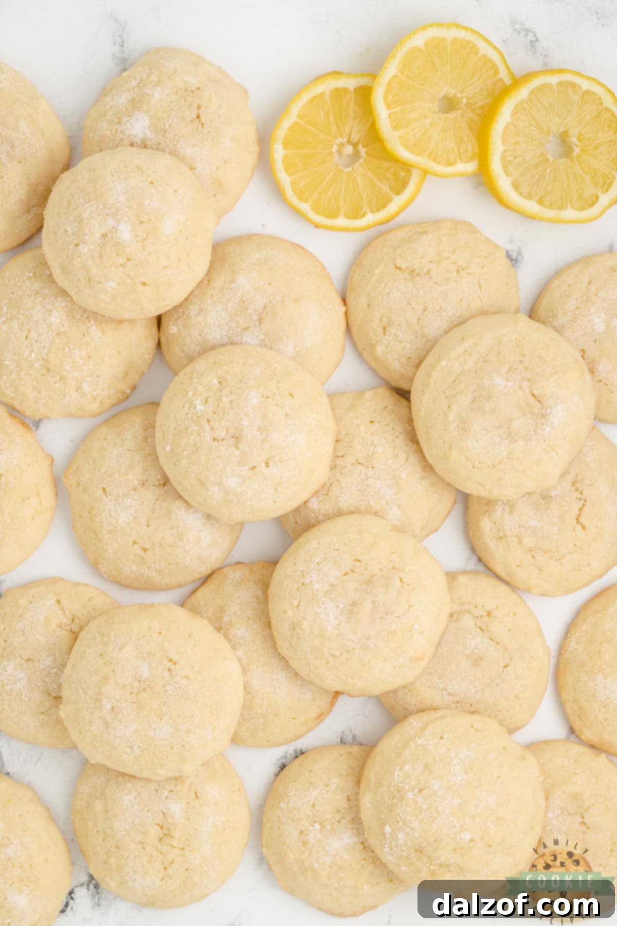 Close-up of simple lemon cookies made with only 6 ingredients, stacked on a cooling rack, showcasing their golden edges and soft centers.