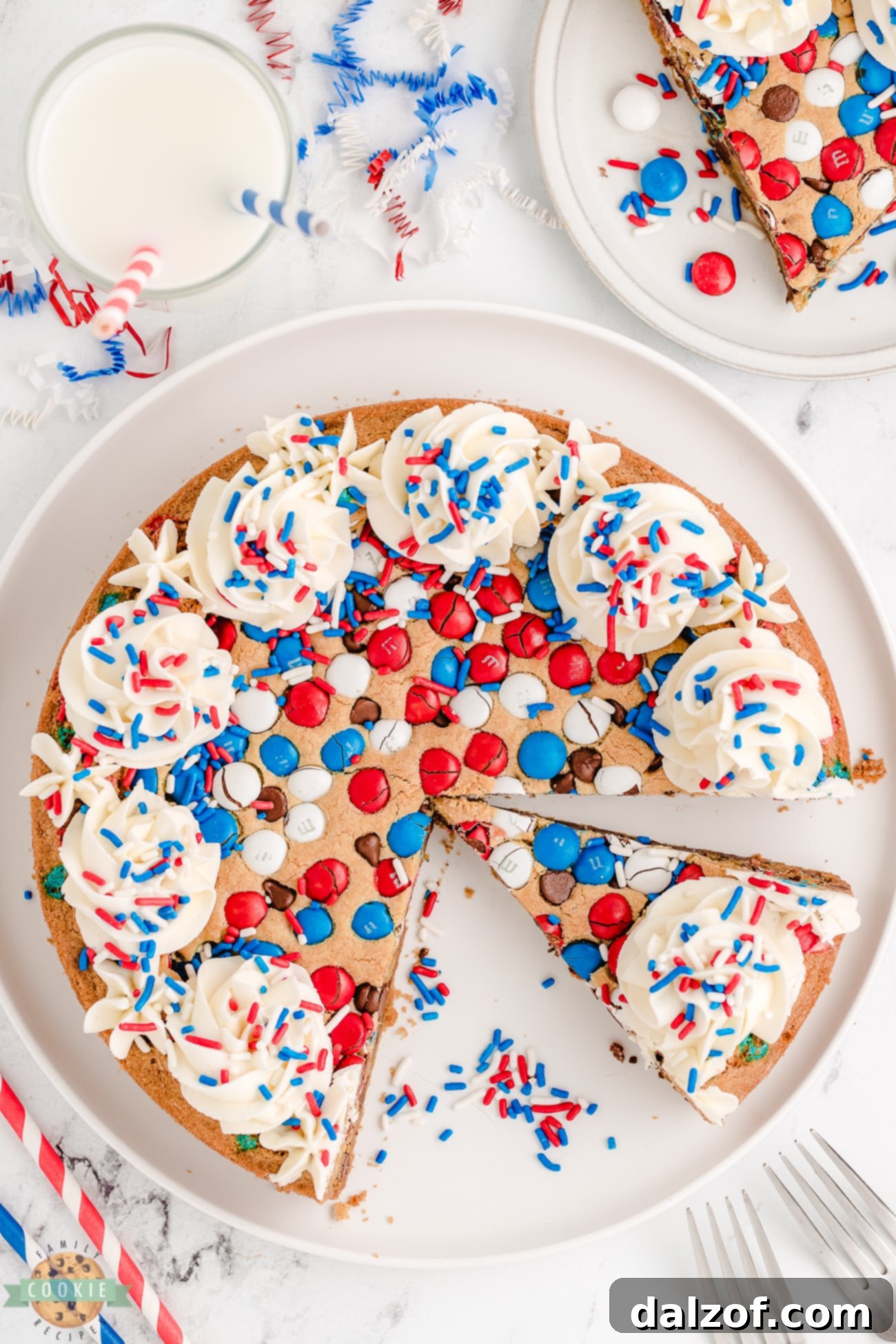 red, white and blue 4th of July cookie cake with slices cut out