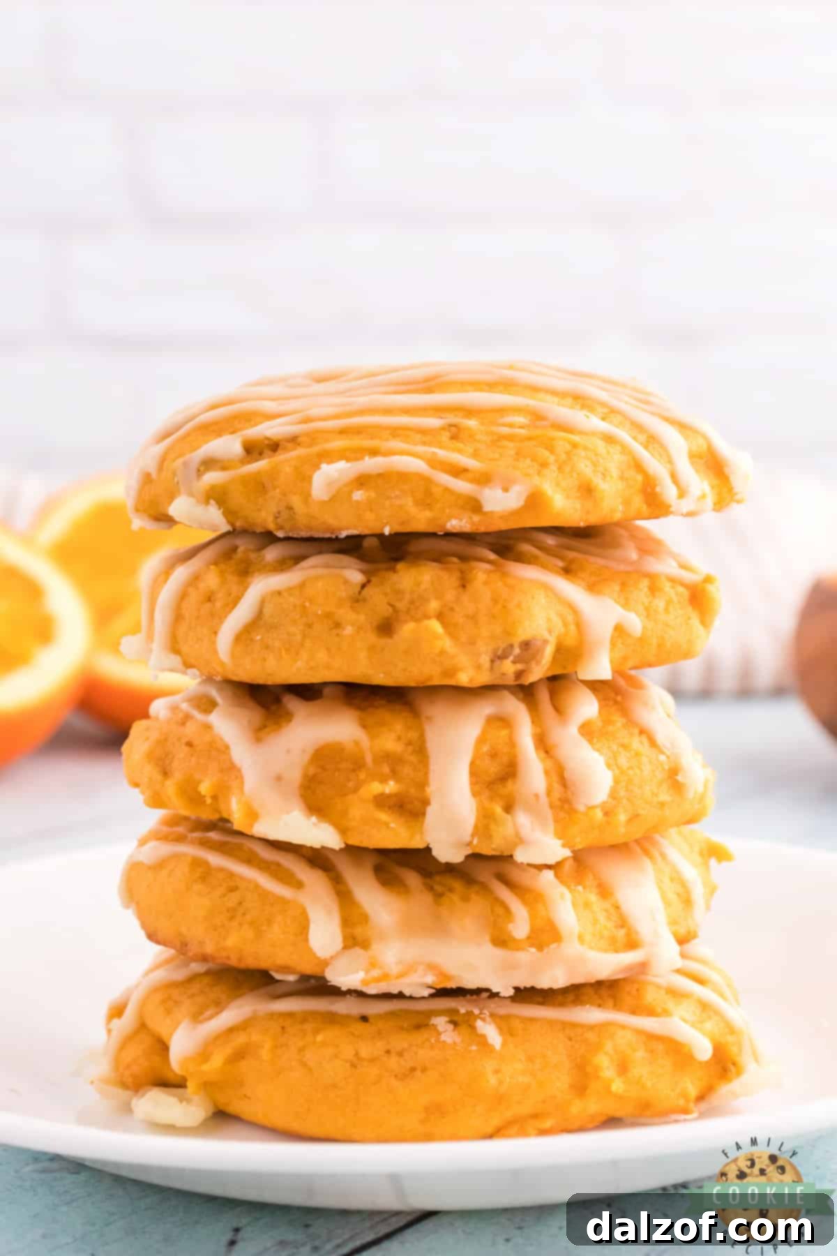 Stack of pumpkin cookies with orange glaze