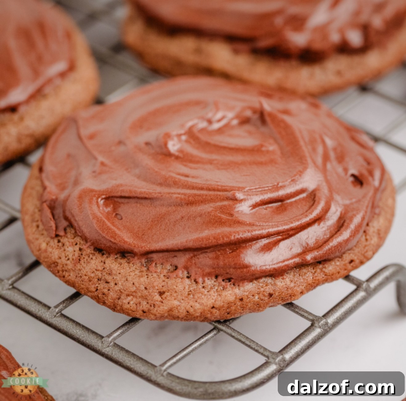 frosted chocolate cookie on a cooling rack