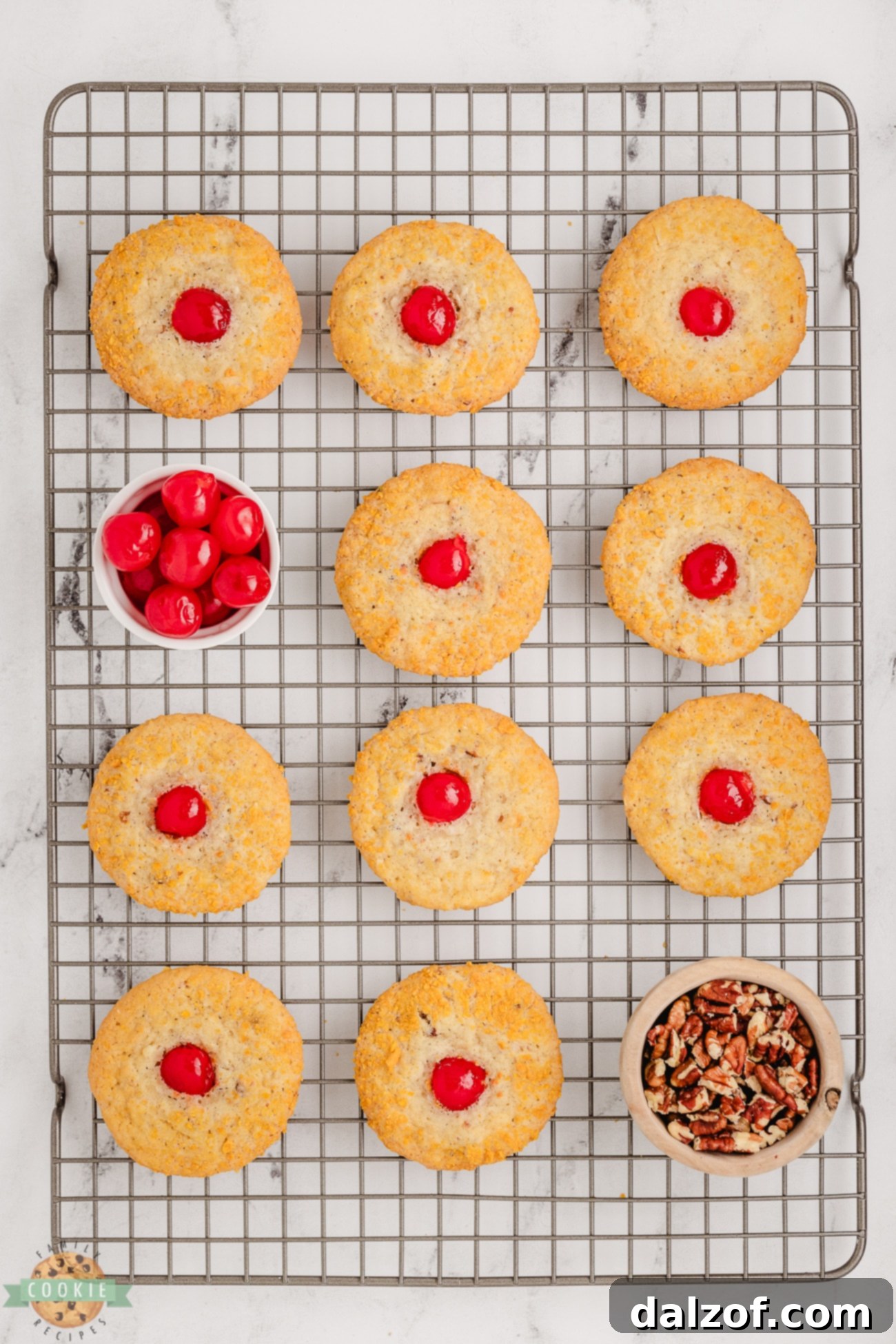 Cherry Crunch Cookies cooling on a wire rack after baking, showing their perfectly golden exterior.
