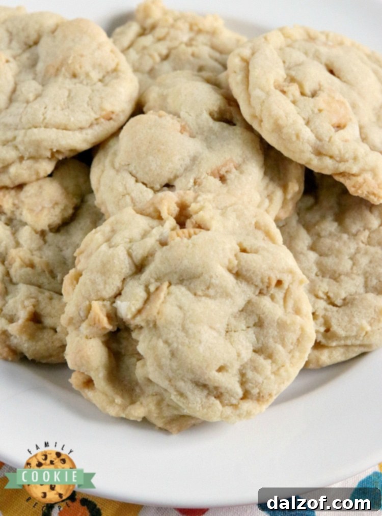 A plate of freshly baked Vanilla Cream Cookies with a glass of milk, showcasing their soft texture and Golden Oreo chunks.