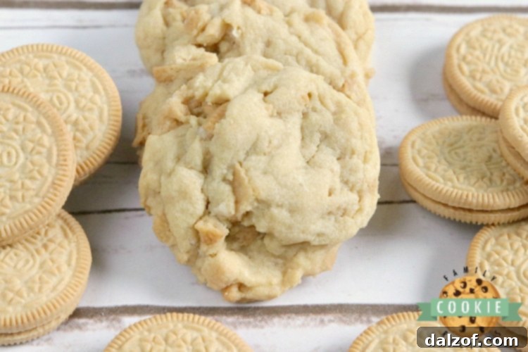 A close-up of a stack of freshly baked Vanilla Cream Cookies on a wooden surface.