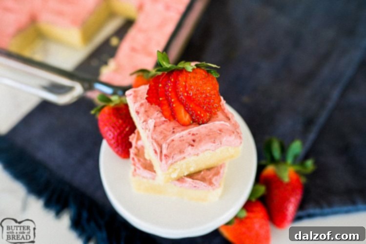 Thick and chewy Strawberry Sugar Cookie Bars topped with vibrant freeze-dried strawberry frosting