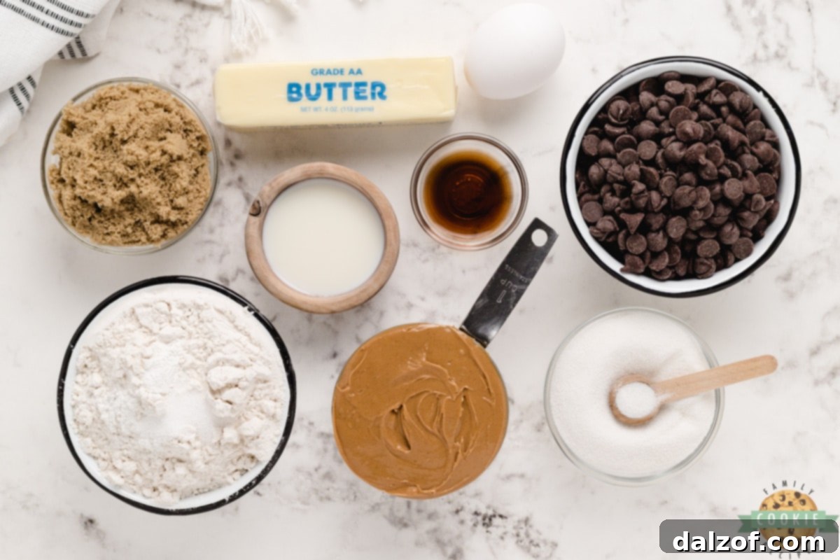 Ingredients for Peanut Butter Chocolate Chip Cookies laid out on a surface.