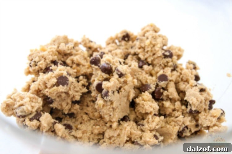 Chocolate chip cookie dough being mixed in a bowl