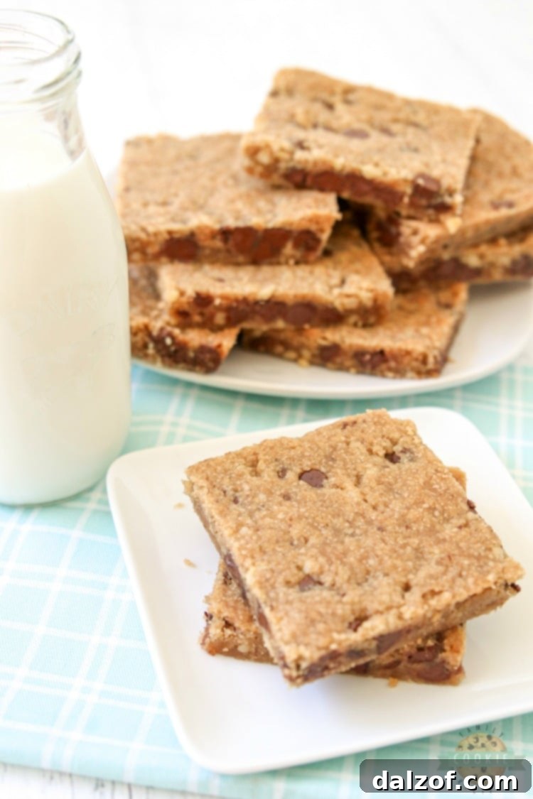 Chocolate chip cookie bars served with a glass of milk