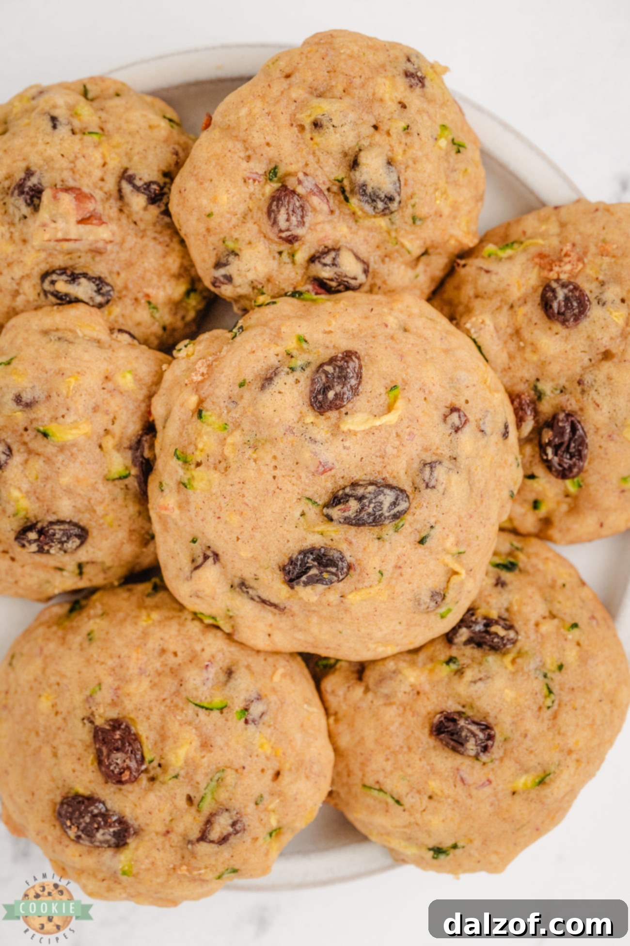 Plateful of soft spiced zucchini breakfast cookies with pecans and raisins