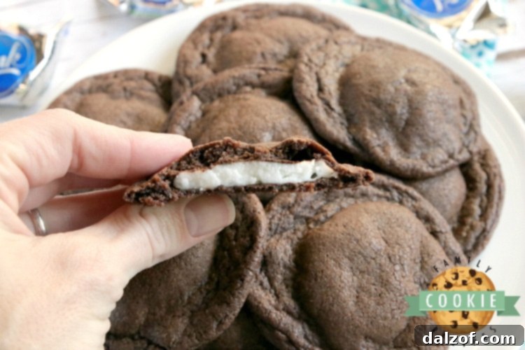 Close-up of baked chocolate cookies revealing a molten York peppermint patty center.