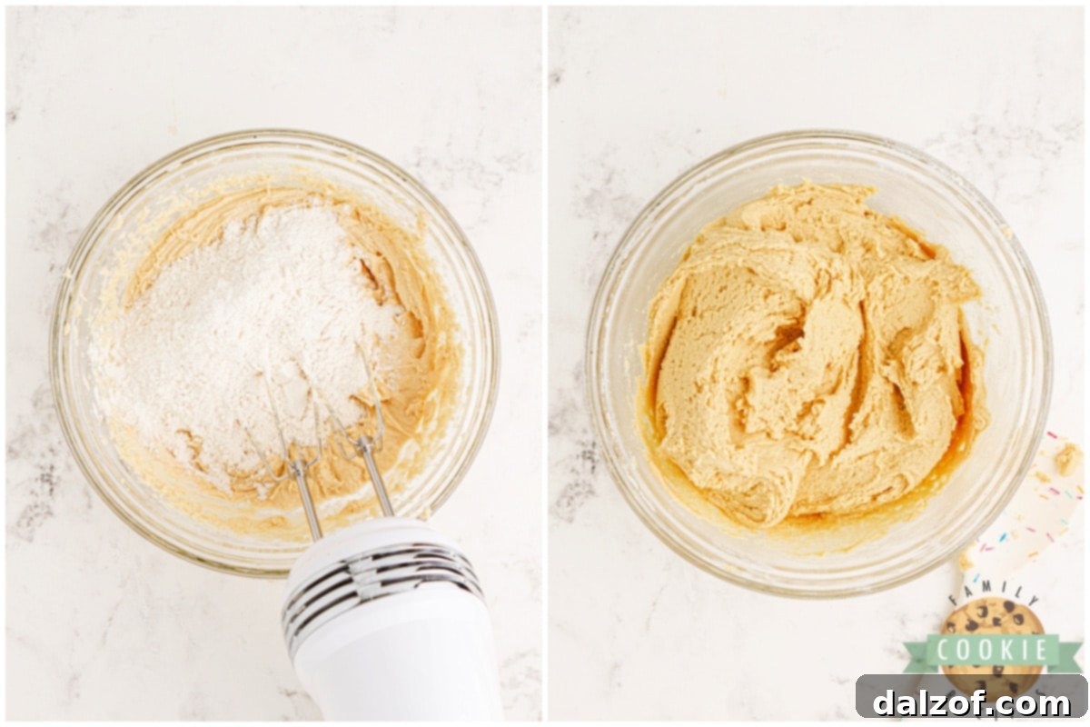 Dry flour mixture being slowly stirred into the creamed butter and sugar, forming the cookie dough.