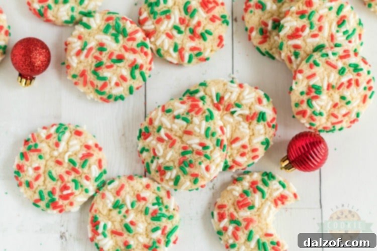 Christmas Sprinkle Cookies are sugar Cookies rolled in Christmas sprinkles for a special holiday treat! Delightfully soft & chewy Christmas cookies made with festive holiday sprinkles!
