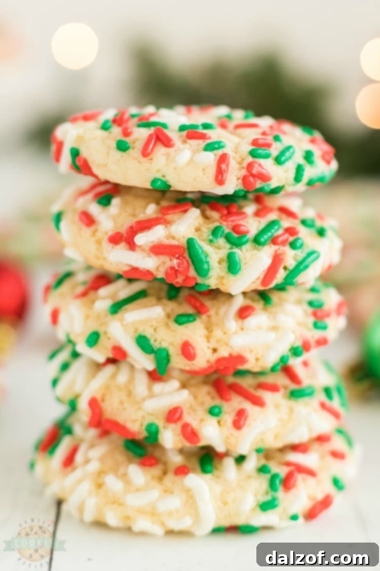 Christmas Sprinkle Cookies are sugar Cookies rolled in Christmas sprinkles for a special holiday treat! Delightfully soft & chewy Christmas cookies made with festive holiday sprinkles!