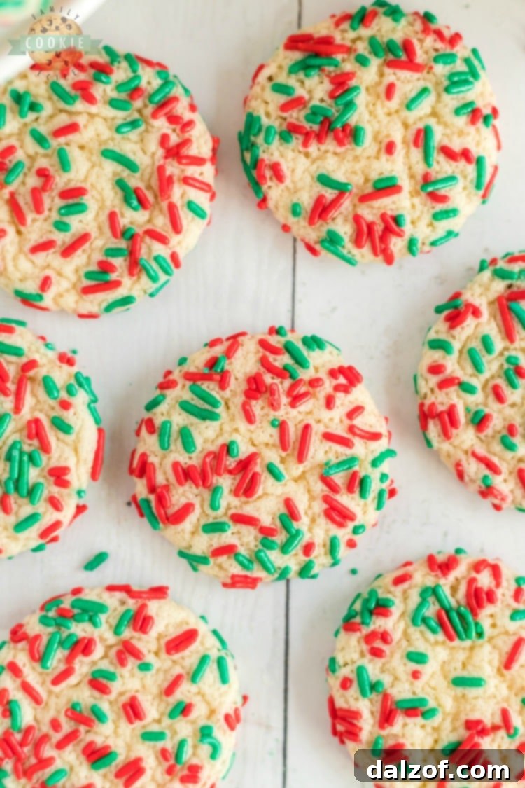 Christmas Sprinkle Cookies are sugar Cookies rolled in Christmas sprinkles for a special holiday treat! Delightfully soft & chewy Christmas cookies made with festive holiday sprinkles!