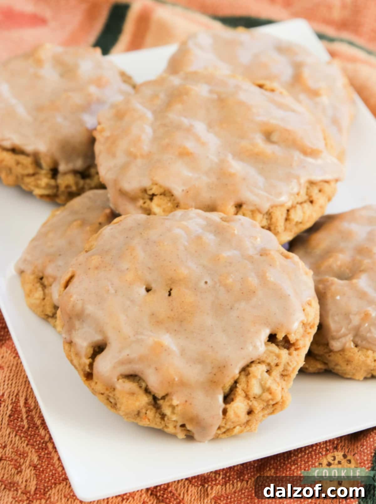 Glazed Pumpkin Oatmeal Cookies are soft, chewy oatmeal cookies packed with pumpkin and topped with a simple cinnamon sugar icing. The perfect cookie for fall!