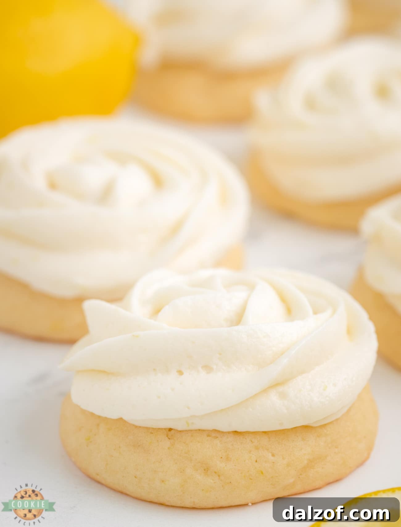 Close-up of a lemon buttercream rosette piped onto a sugar cookie.