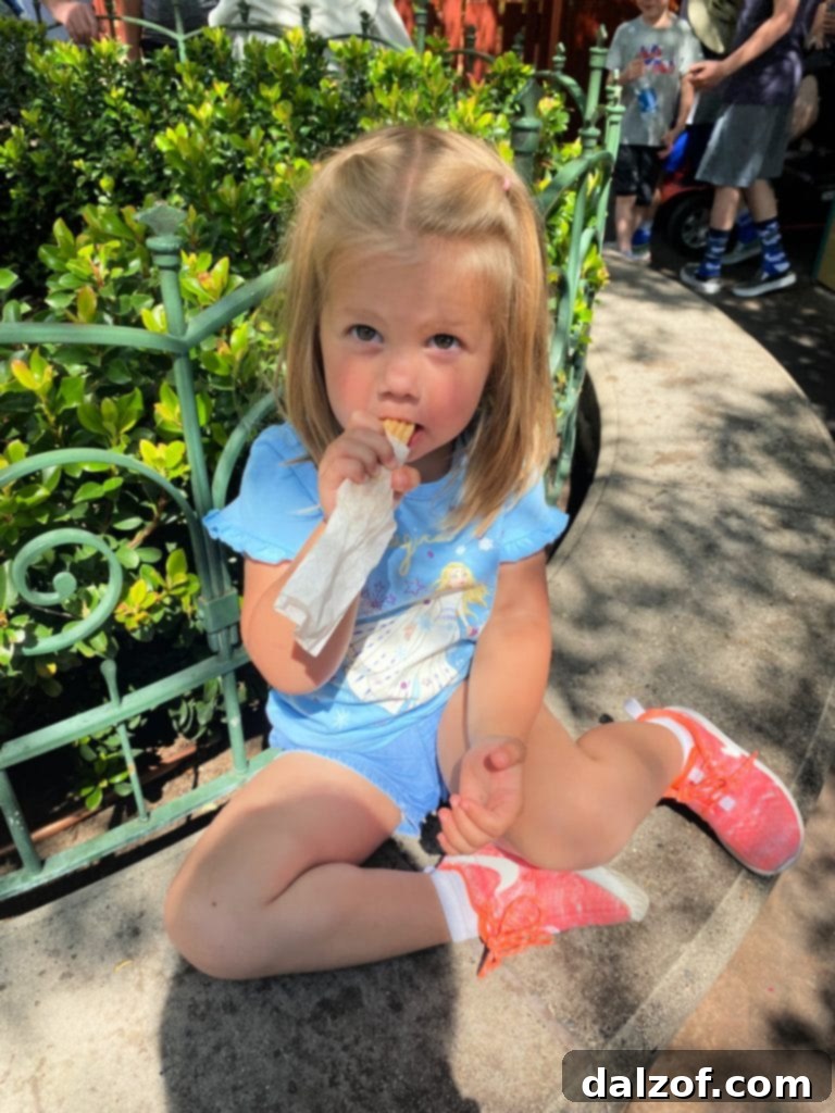 A child enjoying a churro at Disneyland, a sweet memory