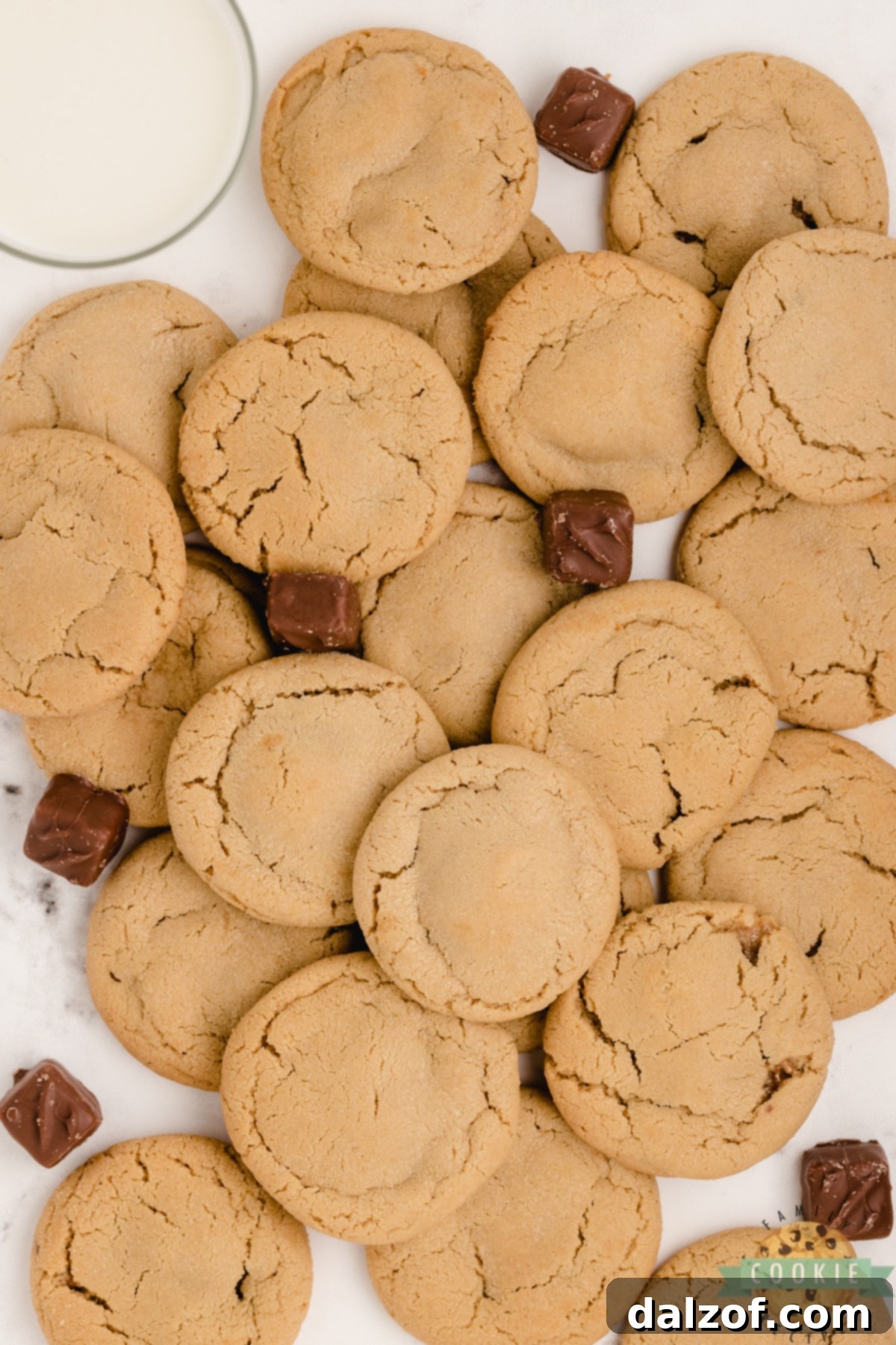 Close-up of a peanut butter cookie revealing a hidden mini Snickers bar inside