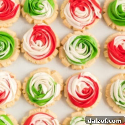 Close-up of a Christmas Frosted Rose Sugar Cookie featuring intricate red and green frosting swirls.