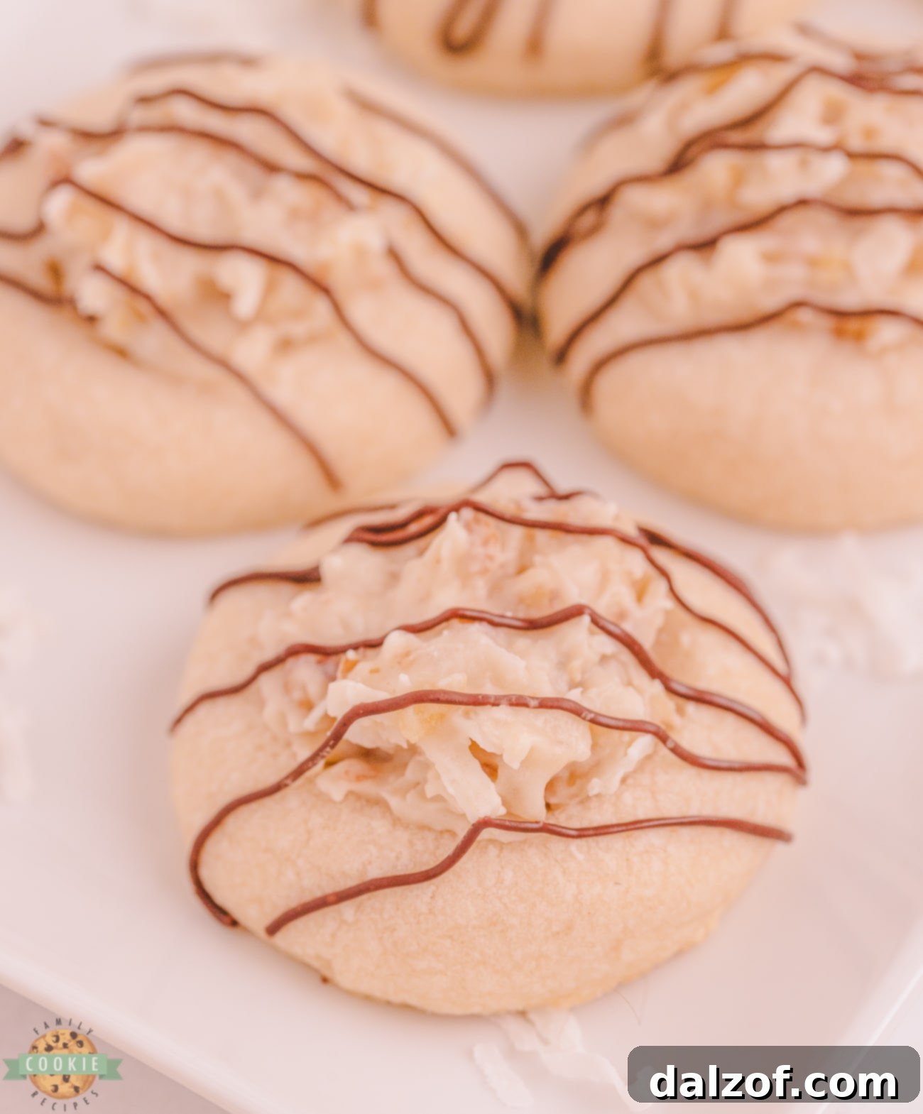 plate of coconut cookies topped with sweet cream cheese