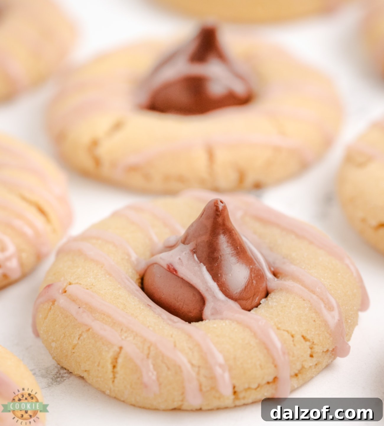 Raspberry Almond Kiss Cookies with a vibrant pink raspberry drizzle