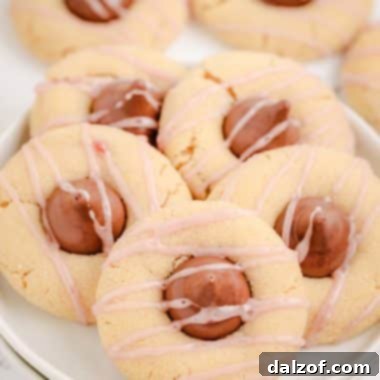 Raspberry Almond Kiss Cookies on a white plate, showcasing their festive appearance