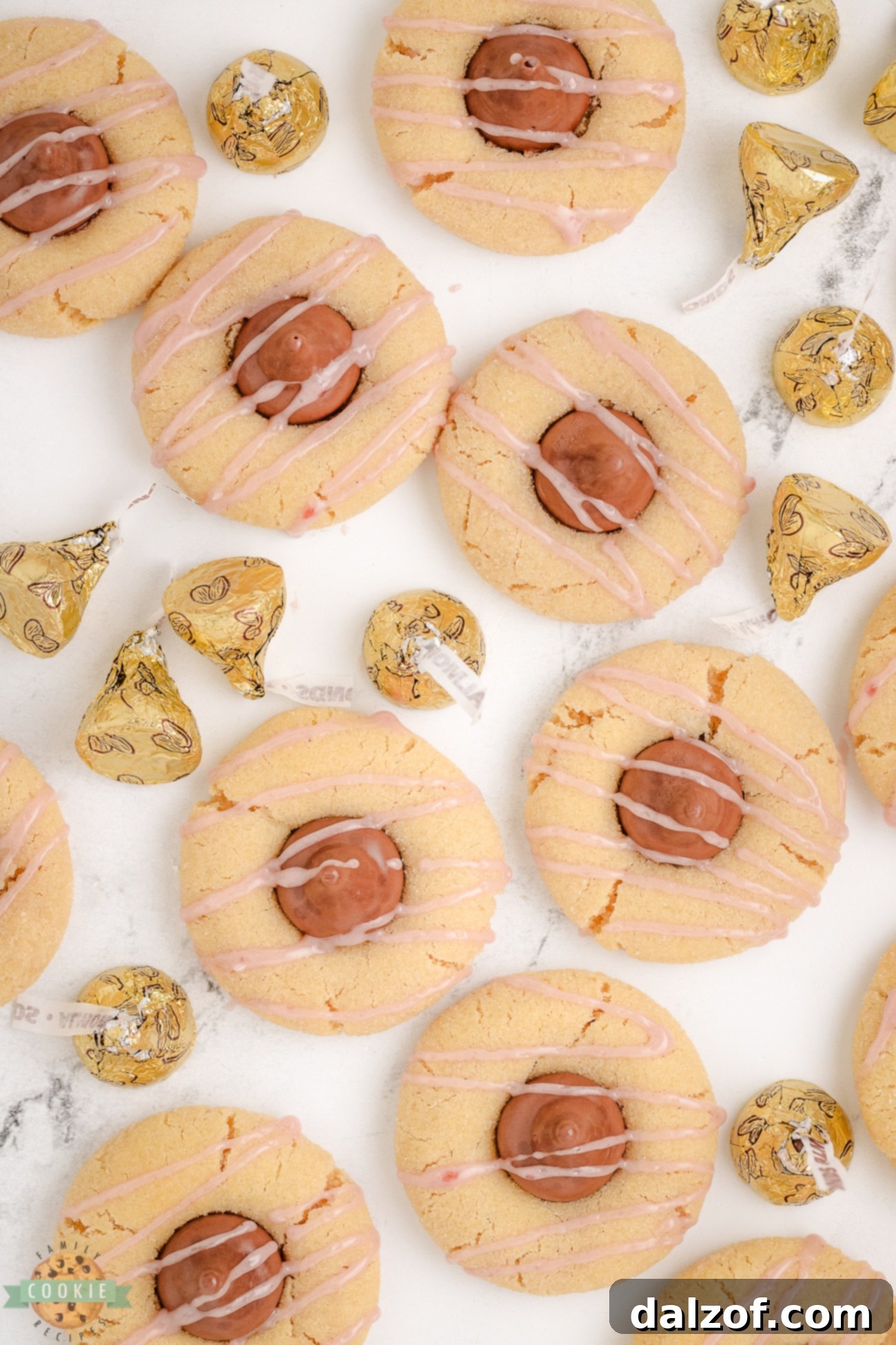 Raspberry Almond Kiss Cookies with almond chocolate kisses and pink glaze ready to serve