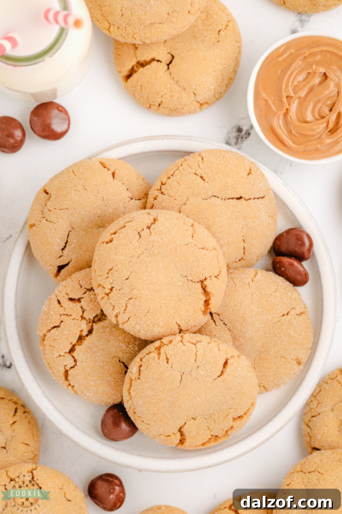 A plateful of freshly baked Peanut Butter Surprise Cookies stuffed with a Milk Dud candy, ready to be enjoyed.