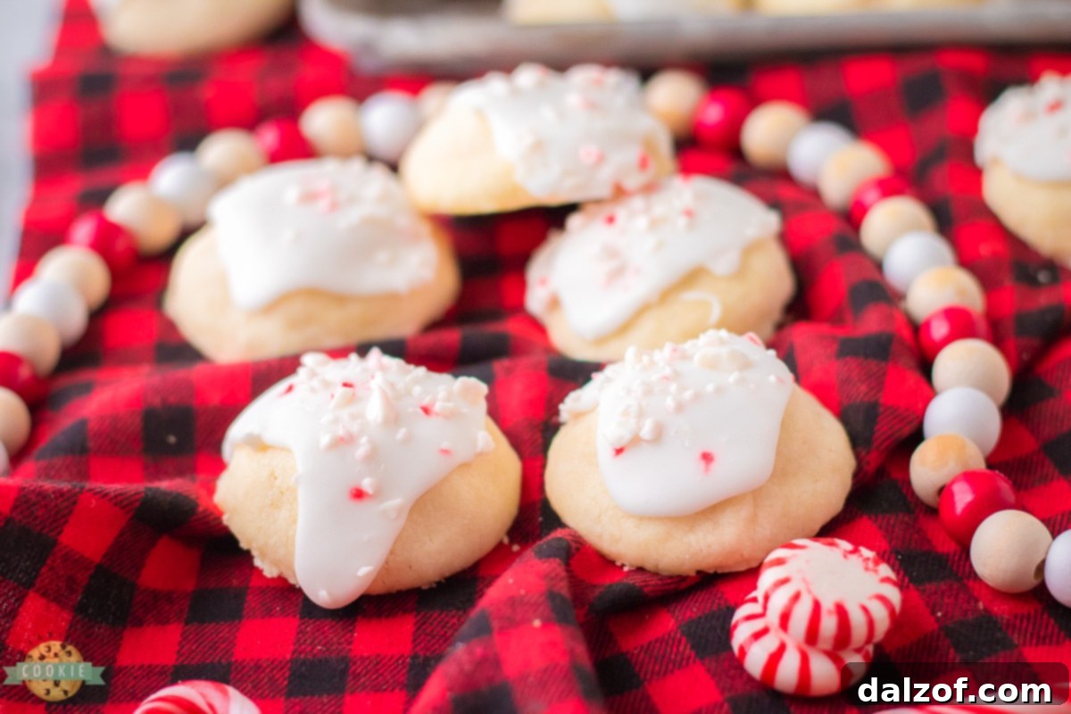 Delicate and festive Peppermint Meltaways, topped with icing and crushed peppermint pieces.