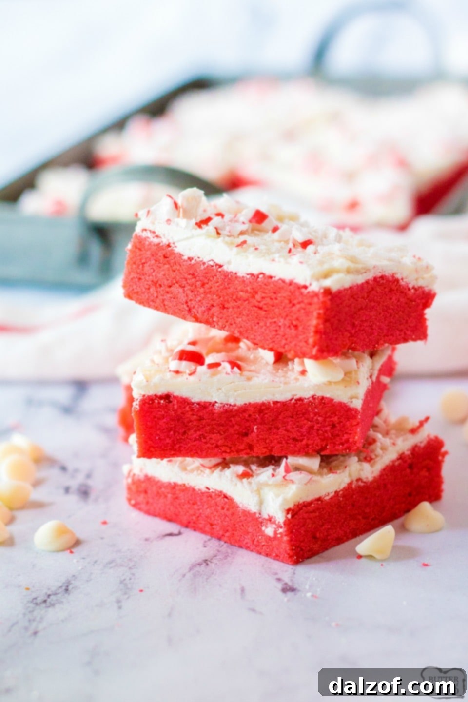 Close-up of festive Peppermint Sugar Cookie Bars, topped with white chocolate and crushed candy canes.